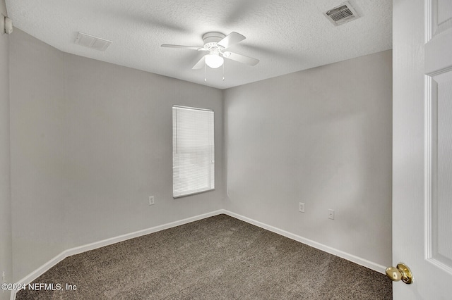 carpeted spare room with ceiling fan and a textured ceiling