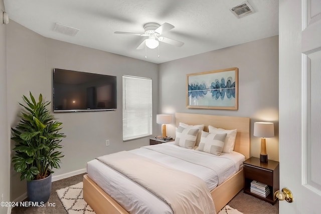 bedroom with carpet flooring, ceiling fan, and a textured ceiling