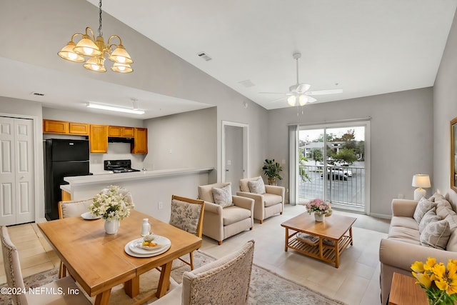 living room featuring ceiling fan with notable chandelier, light tile patterned floors, and high vaulted ceiling