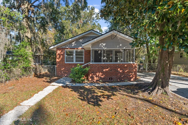 bungalow-style home featuring a sunroom