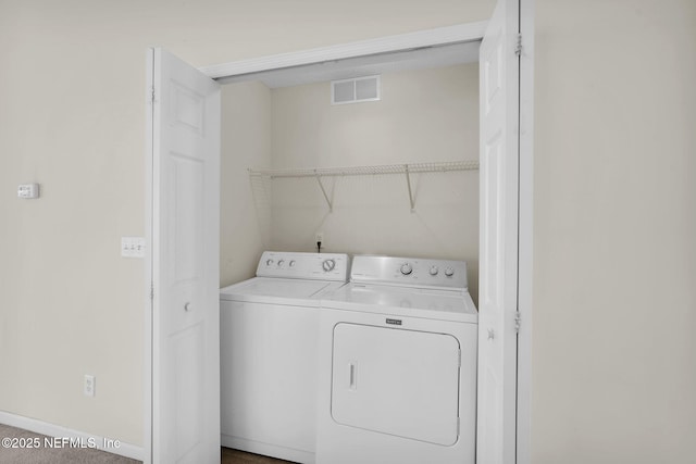 laundry room with washing machine and clothes dryer