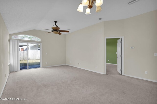 spare room featuring light carpet, ceiling fan with notable chandelier, and vaulted ceiling