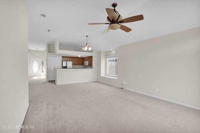 unfurnished living room featuring light carpet, lofted ceiling, and ceiling fan