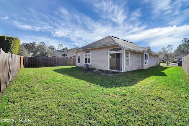 back of property featuring a lawn