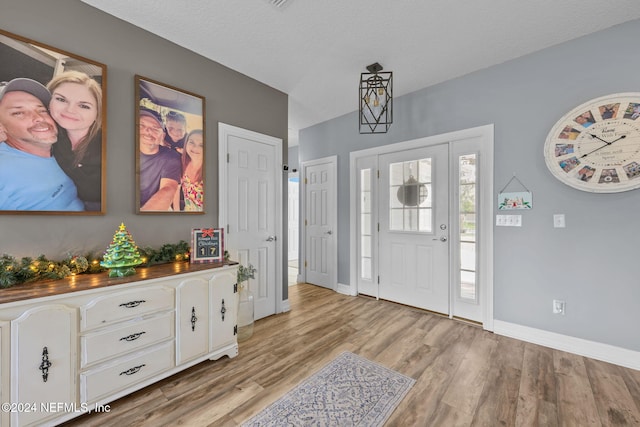 foyer entrance featuring light wood-type flooring and a textured ceiling