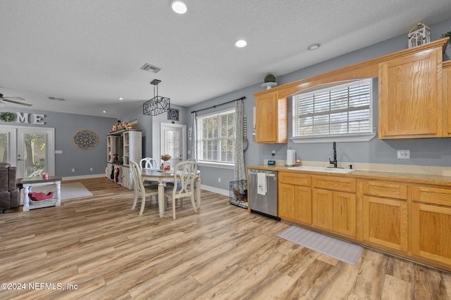 kitchen with pendant lighting, dishwasher, sink, ceiling fan, and light hardwood / wood-style floors