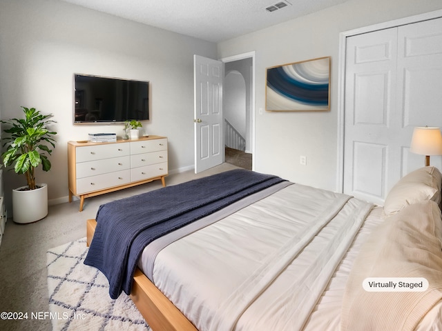 bedroom featuring a textured ceiling and a closet