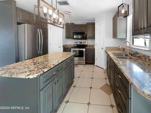 kitchen with sink, hanging light fixtures, appliances with stainless steel finishes, a notable chandelier, and dark brown cabinets