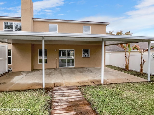 back of property with a patio