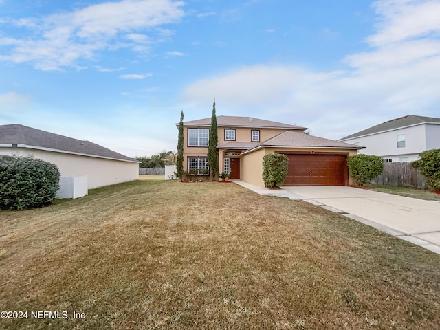 view of front of property with a front yard and a garage