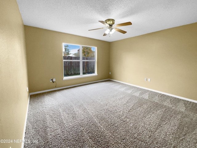 spare room with ceiling fan, carpet, and a textured ceiling