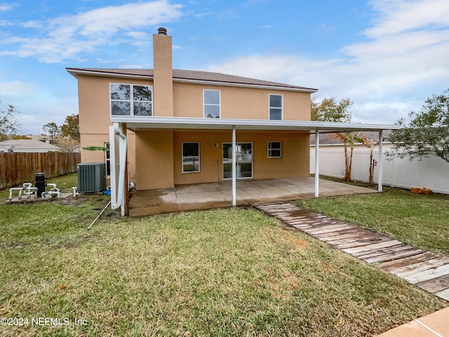 rear view of house featuring a lawn, central air condition unit, and a patio