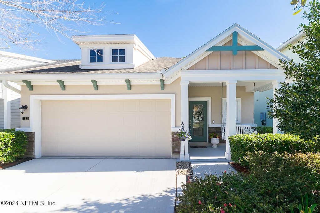 view of front of home with a porch and a garage