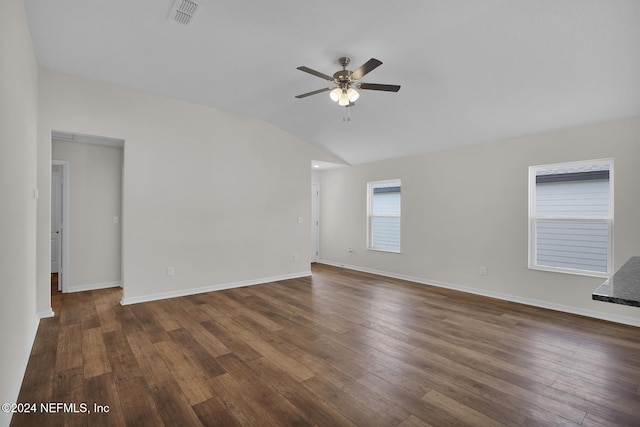 empty room with dark hardwood / wood-style floors, vaulted ceiling, and ceiling fan