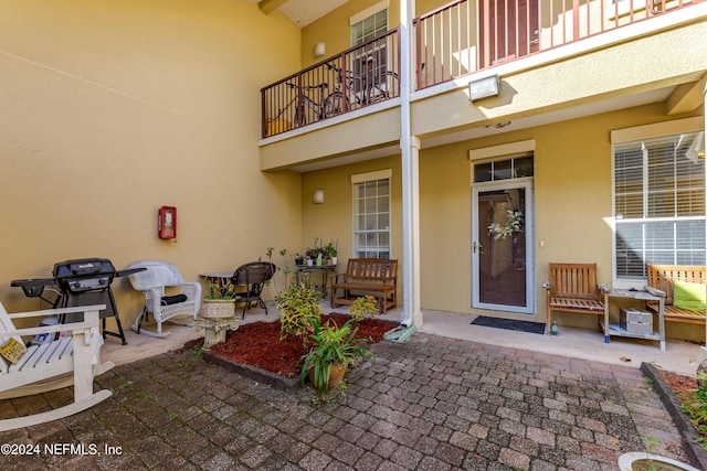 doorway to property featuring a balcony and a patio area