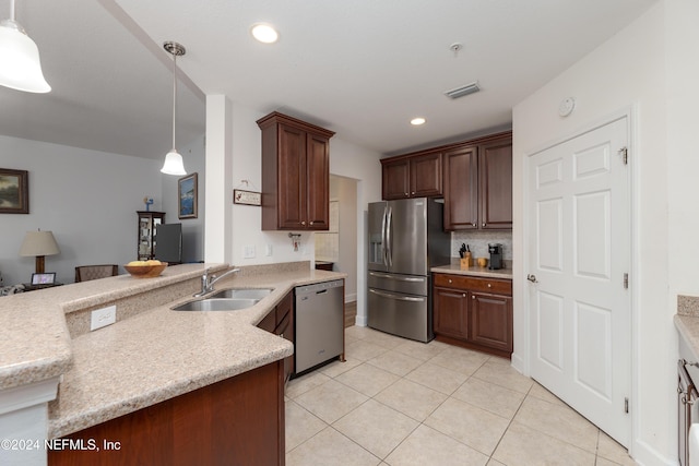 kitchen featuring kitchen peninsula, stainless steel appliances, sink, light tile patterned floors, and hanging light fixtures