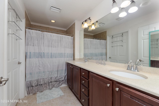 bathroom featuring tile patterned flooring, vanity, and walk in shower