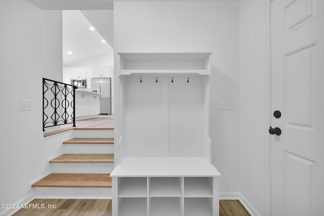 mudroom featuring lofted ceiling and light hardwood / wood-style flooring