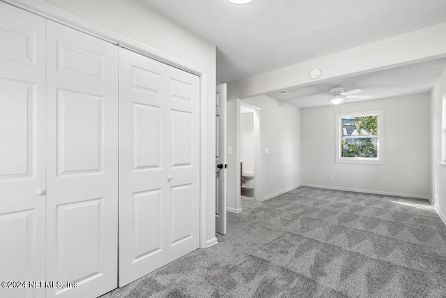 unfurnished bedroom with ceiling fan and light carpet