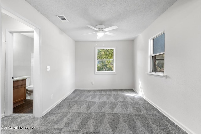 empty room featuring light carpet, a textured ceiling, and ceiling fan