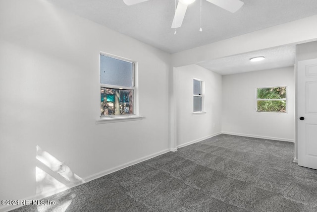 carpeted empty room featuring ceiling fan