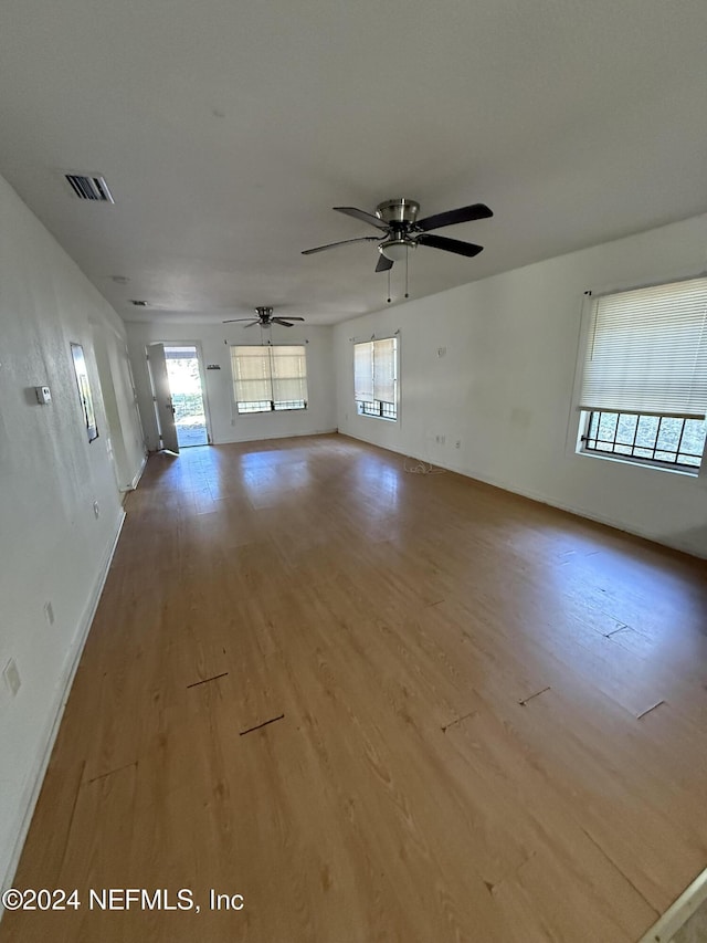 unfurnished living room with light hardwood / wood-style floors and ceiling fan