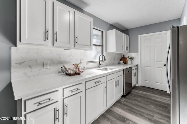 kitchen with white cabinets, sink, tasteful backsplash, dark hardwood / wood-style flooring, and stainless steel appliances