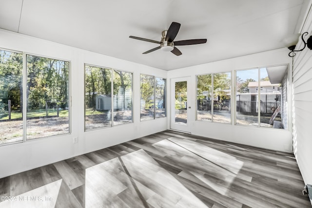 unfurnished sunroom featuring ceiling fan