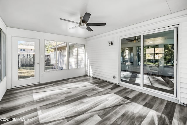 unfurnished sunroom featuring ceiling fan