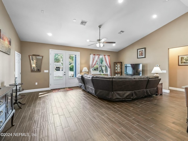 living room with ceiling fan, dark hardwood / wood-style flooring, and vaulted ceiling