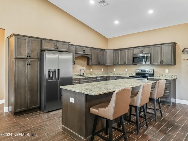 kitchen featuring sink, a center island, dark hardwood / wood-style floors, and appliances with stainless steel finishes