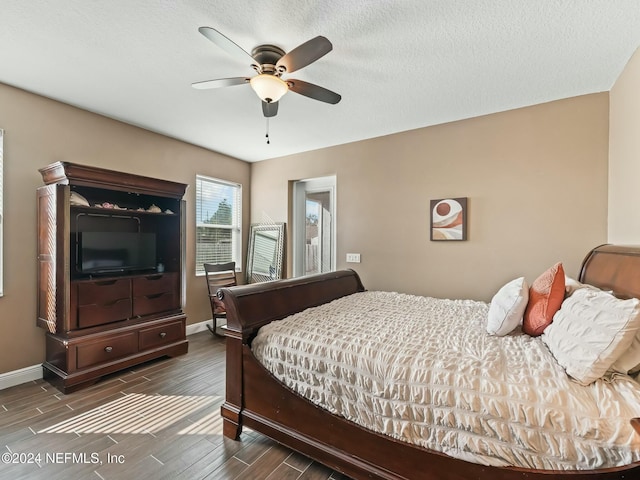 bedroom with a textured ceiling, dark hardwood / wood-style flooring, and ceiling fan