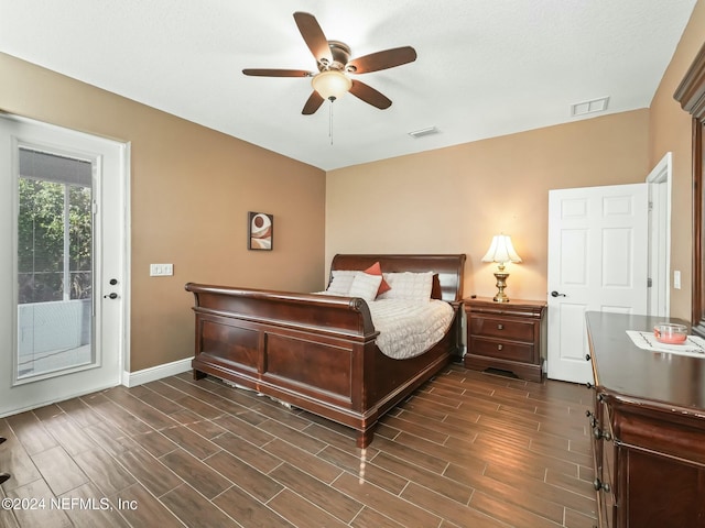 bedroom featuring access to outside, dark hardwood / wood-style floors, and ceiling fan