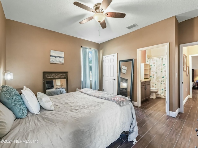 bedroom featuring ensuite bath, ceiling fan, a textured ceiling, dark hardwood / wood-style flooring, and a closet