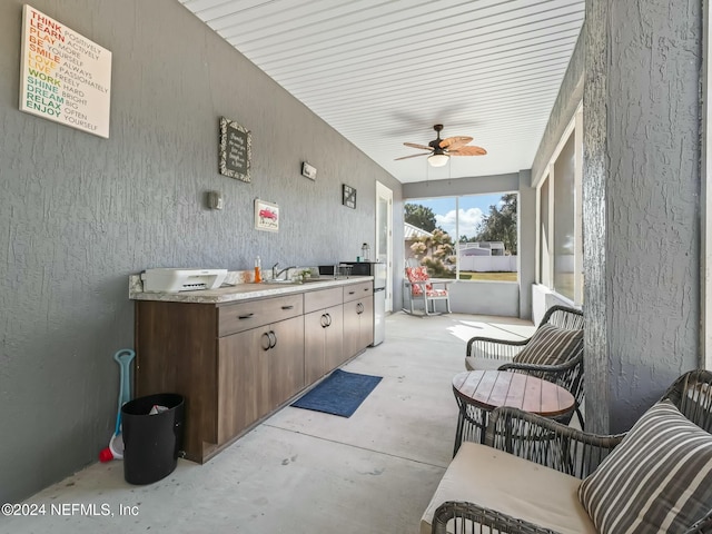 view of patio / terrace with ceiling fan and sink