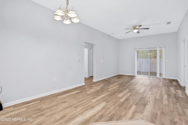 empty room with light hardwood / wood-style floors and ceiling fan with notable chandelier