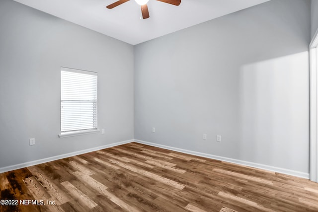 empty room with ceiling fan and dark hardwood / wood-style floors