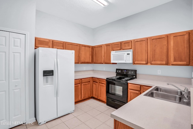 kitchen with white appliances, sink, light tile patterned floors, and a high ceiling