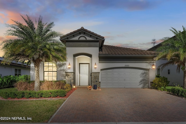 mediterranean / spanish house with a garage