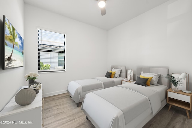 bedroom with light hardwood / wood-style floors and ceiling fan