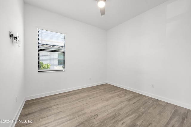 spare room with light hardwood / wood-style floors and ceiling fan