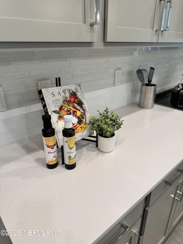 interior details with gray cabinets and decorative backsplash