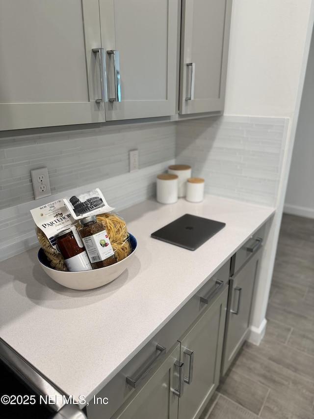 kitchen featuring backsplash and gray cabinets