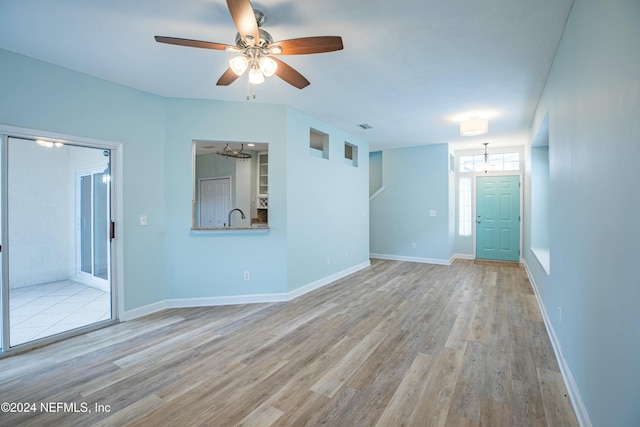 unfurnished room featuring ceiling fan and light hardwood / wood-style flooring