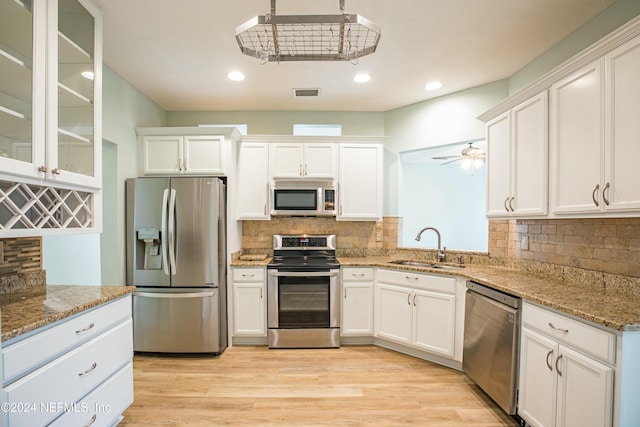 kitchen featuring light hardwood / wood-style floors, sink, white cabinetry, and stainless steel appliances