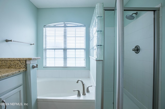 bathroom featuring vanity and separate shower and tub