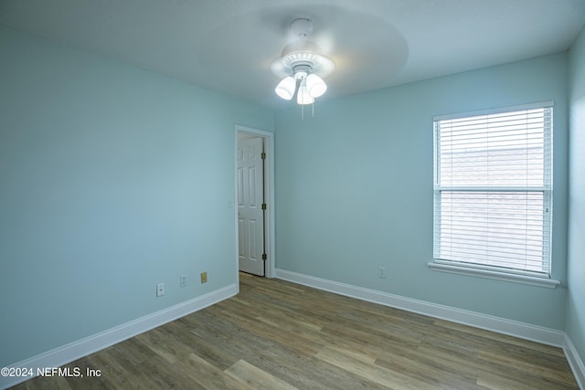 unfurnished room with ceiling fan and wood-type flooring