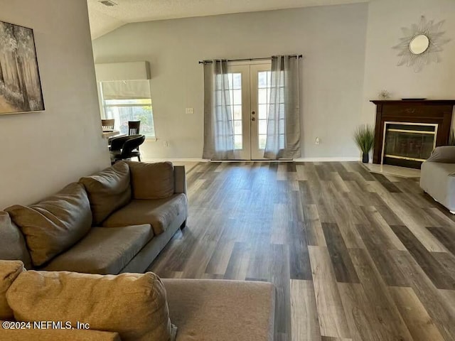 living room featuring french doors, lofted ceiling, and wood-type flooring