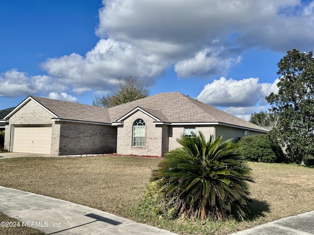 view of front facade with a front yard and a garage