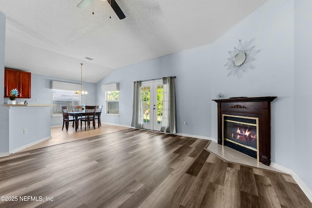 3130 Haverhill Ct, Green Cove Springs, FL 32043 - unfurnished living room with a textured ceiling, wood finished floors, a ceiling fan, and vaulted ceiling